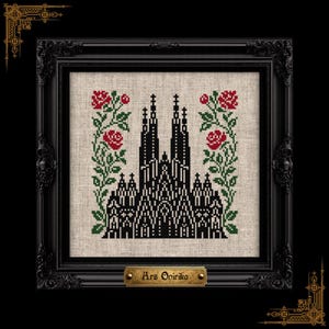 May include: A cross-stitch embroidery on light beige fabric featuring a black gothic cathedral silhouette flanked by two vertical floral vines with red roses and green leaves, encased in a black ornate frame with a gold plaque reading Ars Onirika.