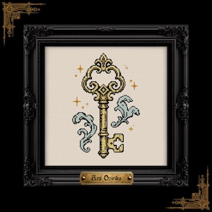May include: A cross-stitch embroidery featuring a gold-colored ornate key with light blue decorative flourishes and small gold star accents on a cream-colored fabric background, encased in a black frame with a plaque reading Ars Onirika.