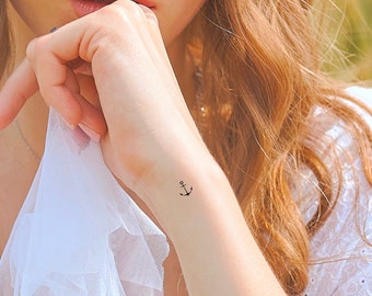 May include: A small anchor tattoo on a person's wrist.