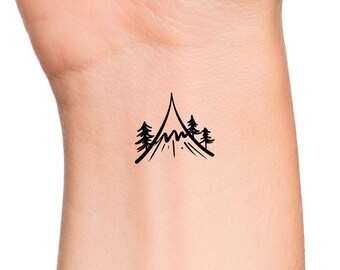 May include: A simple black line drawing of a mountain with two trees on either side. The mountain is drawn with a wavy line to represent the peaks.