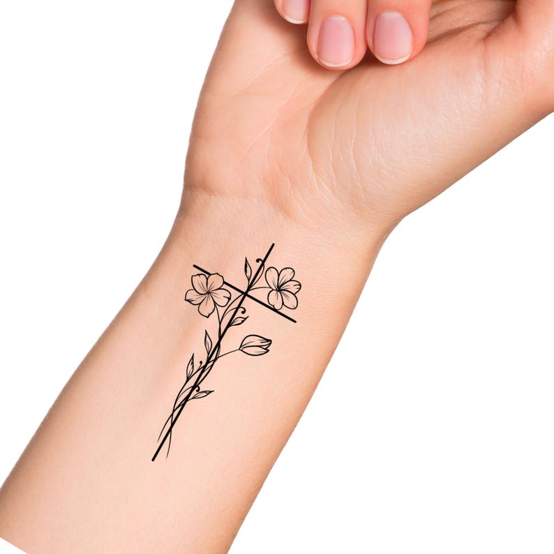 May include: A black line drawing tattoo design of a cross with flowers growing from the centre.