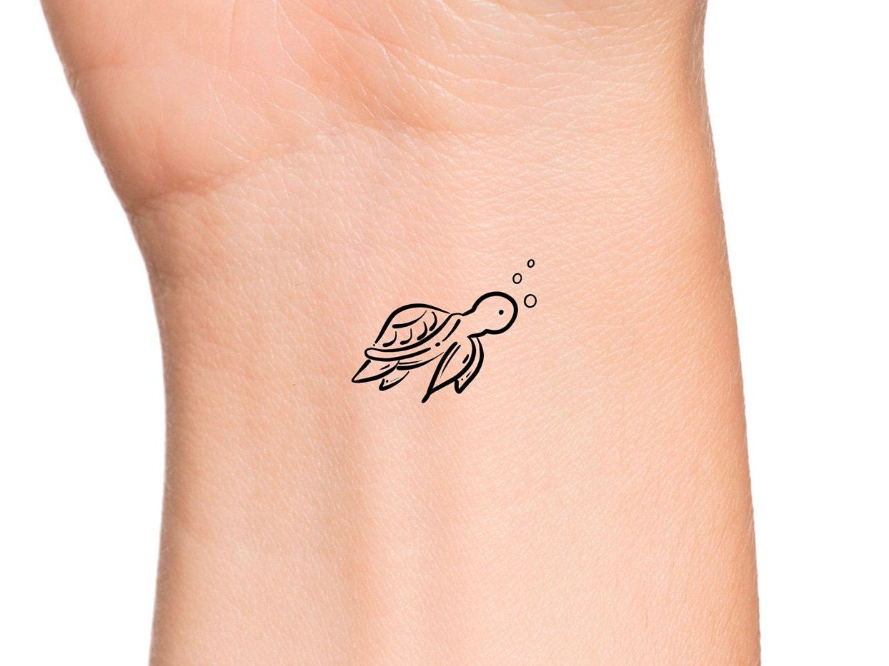 Minimalistic style dolphin temporary tattoo located on
