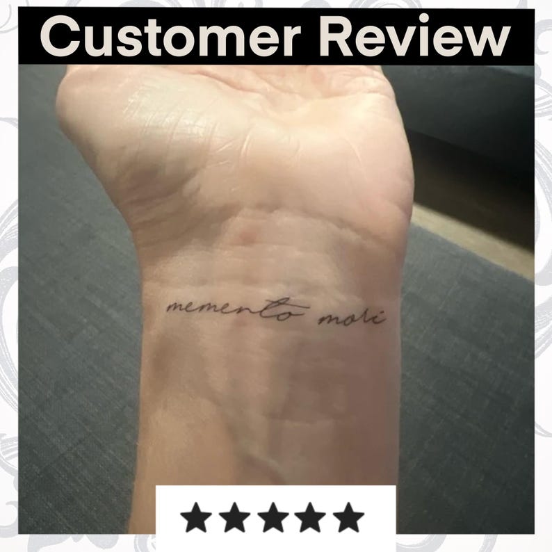 May include: A customer review of a temporary tattoo with the text "memento mori" in cursive script. The tattoo is applied to the wrist of a person. The review is 5 stars.