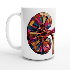 May include: White ceramic mug featuring a colorful, geometric illustration of a kidney. The kidney design incorporates various colors, including red, blue, yellow, and purple. The mug has a curved handle and a smooth, glossy finish.