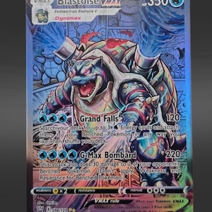 May include: A holographic Blastoise VMAX trading card with 350 HP. The card features a blue, armored turtle creature with cannons on its back, surrounded by comic-style panels. Text includes Grand Falls, G-Max Bombard, and 056/125.