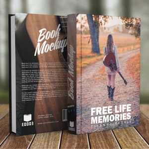 K&ouml;nnte beinhalten: Ein Buch-Mockup mit braunem Holz-Hintergrund und einer Frau, die mit einer Gitarre auf dem R&uuml;cken einen Feldweg entlang geht. Das Buchcover zeigt den Text "FREE LIFE MEMORIES" und den Namen der Autorin "Tiffanny Nevels".