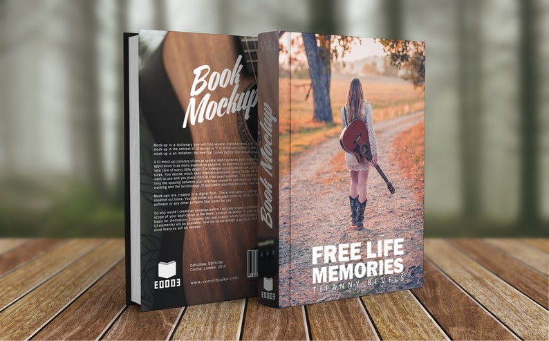 K&ouml;nnte beinhalten: Ein Buch-Mockup mit braunem Holz-Hintergrund und einer Frau, die mit einer Gitarre auf dem R&uuml;cken einen Feldweg entlang geht. Das Buchcover zeigt den Text "FREE LIFE MEMORIES" und den Namen der Autorin "Tiffanny Nevels".