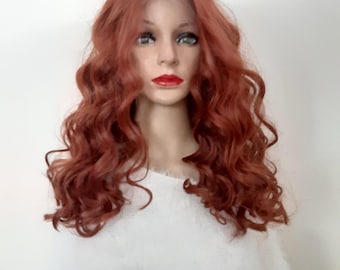 May include: A long, curly, auburn-colored wig with a lace front. The wig is styled in loose waves and falls to the shoulders.