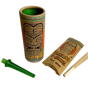 May include: A set of KONE TIKI brand pre-rolled cones and accessories. The set includes a tall, cylindrical container, a smaller package of cones, a green mouthpiece, and a pre-rolled cone. The packaging features a tiki mask design.