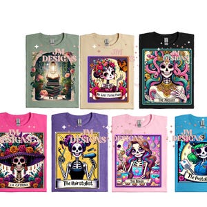 May include: Set of ten t-shirts featuring colorful illustrations of Day of the Dead characters. Each shirt has a different character and a title. The characters include a woman with flowers in her hair, a woman with a book, a woman with snakes, a woman with a skull, a woman with a hair dryer, a woman with a bakery, and a woman with a mail bag.