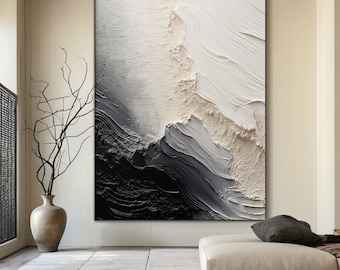 Puede incluir: Pintura abstracta con pintura negra, blanca y gris en un estilo texturizado y en capas. La pintura está enmarcada y colgada en una pared.