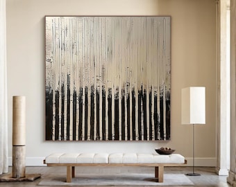 May include: Large abstract painting with vertical black and white brushstrokes. The artwork is framed and hangs above a wooden bench with a white cushion. A floor lamp and decorative wooden pillar are also in the room.