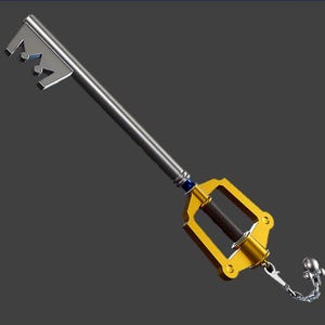 May include: A silver and gold keyblade with a crown-shaped head. The handle is silver, transitioning to a gold hilt with a dark brown center. A small chain and decorative charm hang from the hilt. The keyblade is a fantasy weapon.