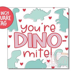 May include: A white 2 inch square tag with a pink and red dinosaur design. The tag says "You're Dino-mite!" with hearts and dinosaurs in the background.