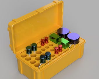May include: A yellow plastic storage case with a lid open, revealing a variety of small, colourful cylindrical and rectangular objects. The case has a grid of circular compartments.