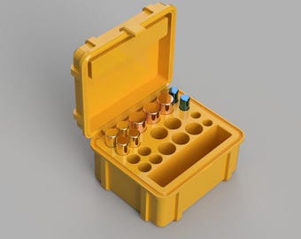 Puede incluir: Una caja de plástico amarilla con una tapa que se abre para revelar un compartimento con varios recipientes pequeños redondos. Los recipientes están llenos de artículos de varios colores, incluyendo oro, cobre y azul.