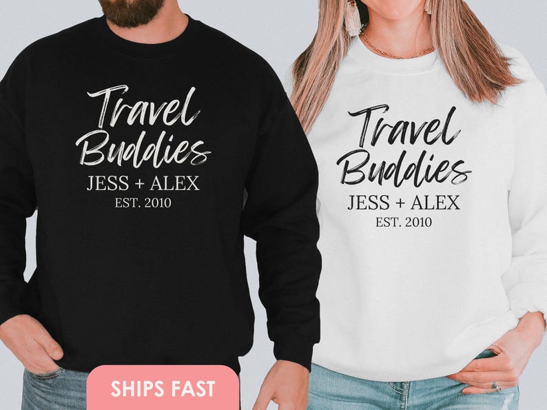 May include: Two black and white sweatshirts with the text "Travel Buddies Jess + Alex Est. 2010" on the front.
