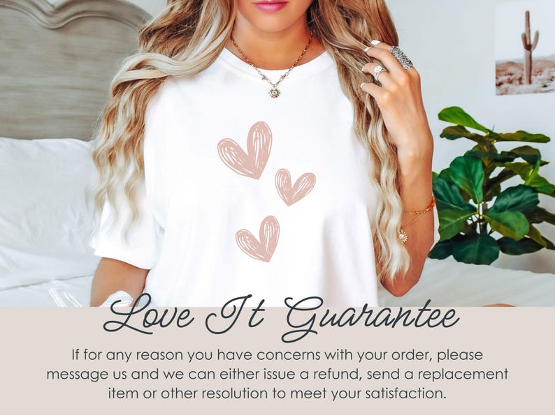 May include: White t-shirt featuring three pink heart designs. The text "Love It Guarantee" is displayed at the bottom of the image.