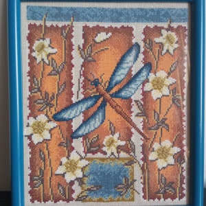 The painting &quot;Dragonfly&quot; is embroidered with a cross and decorated under glass.completed cross stitch picture. Finished work. handmade