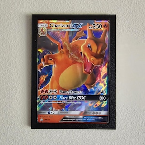 May include: Charizard GX Pokemon card with a red, orange, and yellow Charizard illustration. The card has a black border and the text "Charizard GX" and "HP 250".