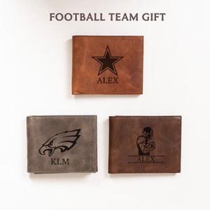 May include: Three leather wallets with football-themed designs. One is brown with a star and the name "ALEX", another is gray with an eagle head and the initials "KLM", and the third is brown with a football player and the name "ALEX". The text "FOOTBALL TEAM GIFT" is at the top.