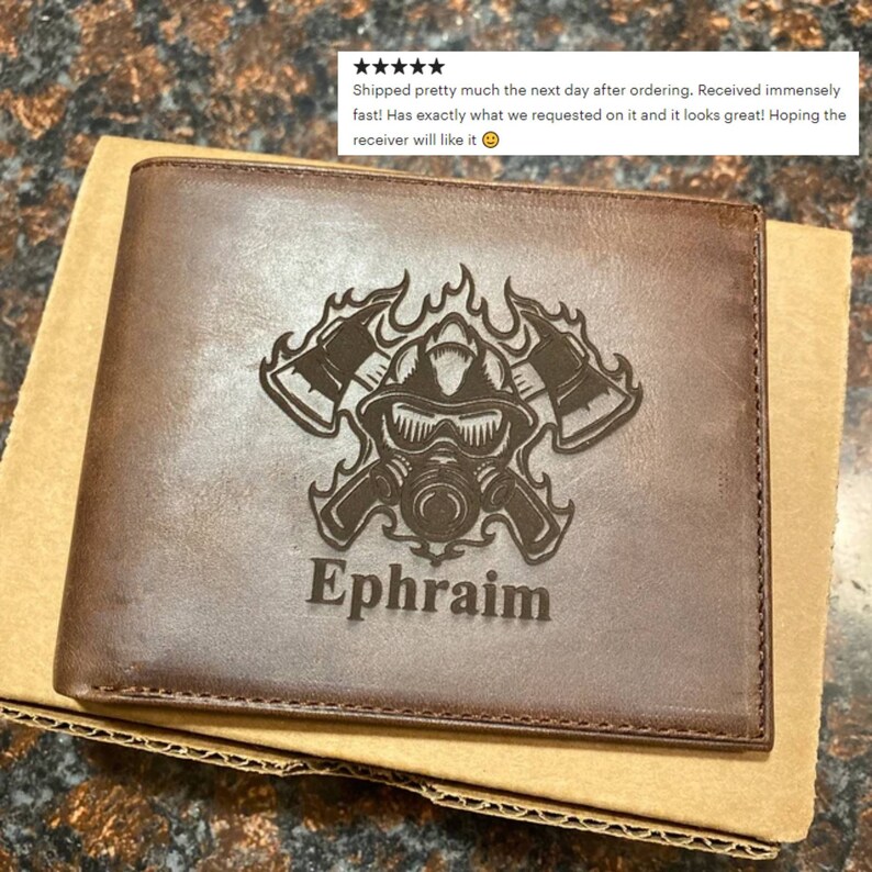 May include: Brown leather wallet with a firefighter design and the name Ephraim engraved on it.
