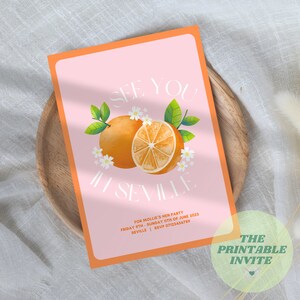 May include: Orange themed invitation for a hen party in Seville, Spain. The invitation features a watercolor illustration of an orange with white flowers and green leaves. The text reads "See you in Seville" and includes the date and RSVP information.