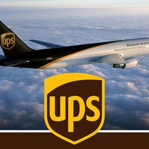 May include: A white and brown cargo airplane flying above clouds with the UPS logo on the tail and the text Worldwide Services Synchronizing the world of commerce on the fuselage, featuring a large UPS shield logo in the foreground.