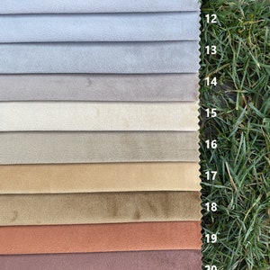 May include: A fabric swatch sample set featuring eleven horizontal strips of velvet-like material in a gradient of colours ranging from light grey to beige, tan, brown, terracotta, and mauve, each labelled with numbers 11 through 21.