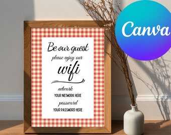 May include: A framed sign with a red and white gingham pattern border. The sign says "Be our guest please enjoy our wifi" and includes spaces for the network name and password. The sign is sitting on a table with a vase of dried flowers.