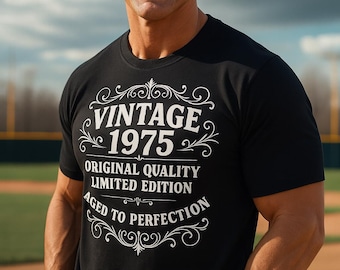 May include: Black t-shirt with the text "VINTAGE 1975 ORIGINAL QUALITY LIMITED EDITION AGED TO PERFECTION" in white script. The shirt has a classic design and is worn by a person.