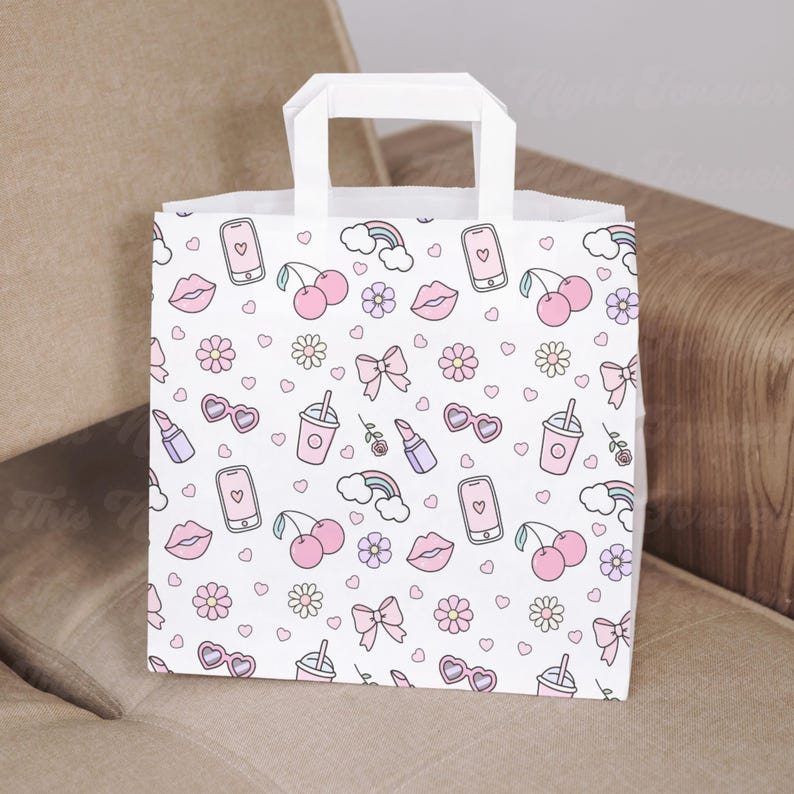 May include: White paper gift bag with a pink and white pattern of cherries, lips, hearts, sunglasses, cell phones, bows, rainbows, and drinks.