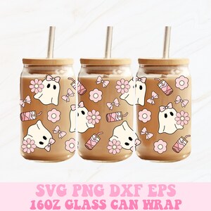 May include: Three glass can wraps with wooden lids and straws, filled with a light brown liquid. Each can features a cute ghost design with pink bows and flowers. The text at the bottom reads "16oz Glass Can Wrap".