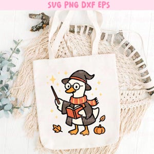 May include: White tote bag featuring a cartoon goose dressed as a wizard, wearing a hat, scarf, and glasses, holding a wand and a book. The design includes stars, leaves, and a pumpkin. Text at the top reads "SVG PNG DXF EPS".