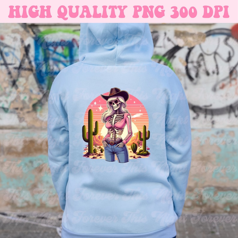 May include: Light blue hoodie with a graphic of a skeleton cowgirl in a desert scene. The design features a cowgirl skeleton wearing a pink top, jeans, and a cowboy hat, with cacti and a sunset in the background. Text at the top reads "HIGH QUALITY PNG 300 DPI."