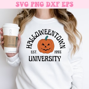 May include: White sweatshirt with a black graphic design that says "Halloweentown University Est. 1998" with a cartoon orange pumpkin with a black face.