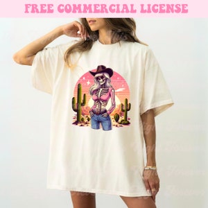 May include: Cream-colored t-shirt featuring a desert-themed graphic. The graphic depicts a skeleton wearing a cowboy hat, sunglasses, and a pink top, standing in front of a sunset and cacti. The text "FREE COMMERCIAL LICENSE" is at the top.