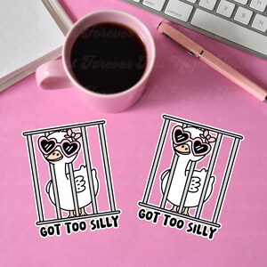 May include: Two white cartoon geese wearing pink heart-shaped sunglasses are in gray cages. The text "Got Too Silly" is below each goose.