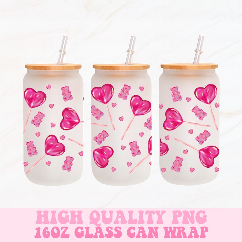 May include: Three frosted glass can wraps with bamboo lids and clear straws. Each features a pattern of pink heart-shaped lollipops, gummy bears, and small hearts. The text at the bottom reads "HIGH QUALITY PNG 16OZ GLASS CAN WRAP."