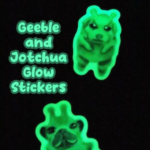 May include: Two glow-in-the-dark stickers featuring cartoon animals. The first sticker is a hamster with a light green body and a dark green face. The second sticker is a pug with a light green body and a dark green face. The text "Geeble and Jotchua Glow Stickers" is written in green.