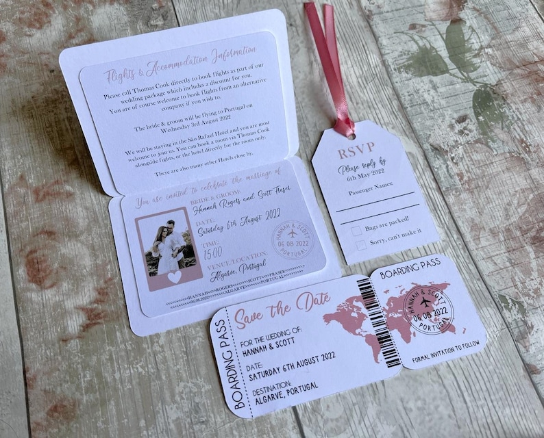 May include: A pink and white save the date card with a passport and boarding pass design. The card features a photo of a couple, a world map, and the text "Save the Date" for the wedding of Hannah & Scott on Saturday, August 6th, 2022 in Algarve, Portugal.