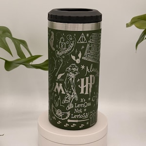 May include: Green insulated drinks tumbler with a black lid and silver trim. The tumbler features white illustrations and text from the Harry Potter series, including the words "Alohomora" and "Always". The text "It's Leviosa Not LevioSA!" is also visible.