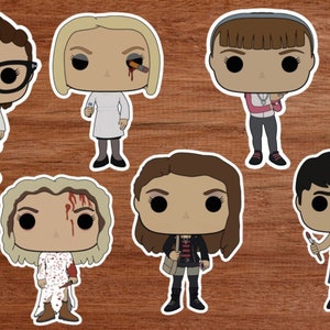 May include: Set of seven pop culture vinyl figures, each with a unique design and personality. The figures are all in a cartoon style and feature different hairstyles, clothing, and accessories.