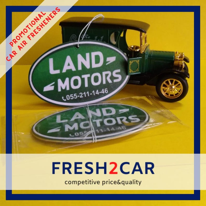 May include: Green and white oval car air fresheners with the text "LAND MOTORS" and a phone number, next to a green vintage car model. The words "PROMOTIONAL CAR AIR FRESHENERS" are printed on the left side.