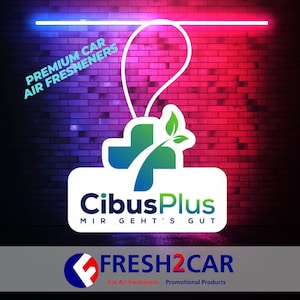 May include: Image of a car air freshener with the text "PREMIUM CAR AIR FRESHENERS". The logo includes a cross with green leaves and the text "CibusPlus" and "FRESH2CAR". The background is a brick wall with blue and red lighting.