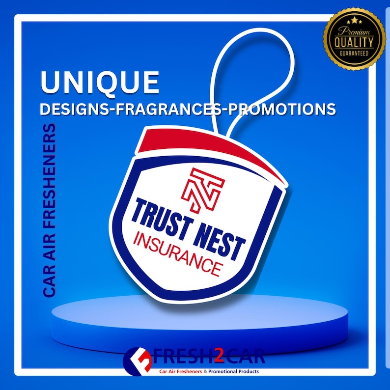 May include: A car air freshener with a shield design, featuring the text "TRUST NEST INSURANCE" in white and blue, with a red and white logo. The background is blue with the words "UNIQUE DESIGNS-FRAGRANCES-PROMOTIONS".