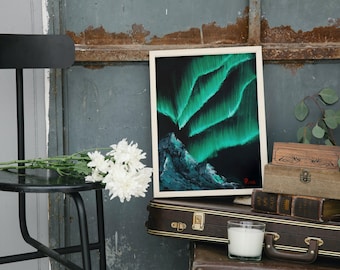 May include: A framed painting of the aurora borealis, also known as the Northern Lights, in shades of green and blue against a black background. The painting is displayed on a shelf with other decorative items.