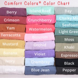 May include: A color chart of Comfort Colors&reg; t-shirt fabric swatches. The chart includes 18 different colors, including berry, crimson, yam, terracotta, mustard, banana, ivory, white, island reef, crunchberry, watermelon, blossom, orchid, violet, chambray, blue jean, bay, chalky mint, seafoam, light green, moss, khaki, espresso, black, and pepper.