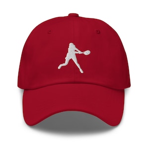 May include: Red baseball cap with a white embroidered silhouette of a person playing tennis.