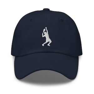 May include: Navy blue baseball cap featuring a white embroidered tennis player silhouette. The cap has a curved brim and an adjustable strap at the back. A stylish accessory for tennis enthusiasts.